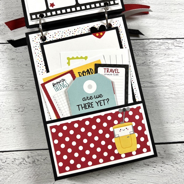 Disney themed scrapbook album page with a pocket, journaling cards, & tags