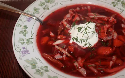 Eating a bowl of borscht.