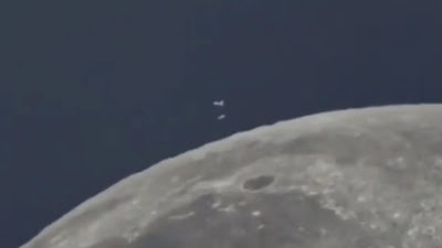 Guy films group of UFOs over the Moon from Earth in the daytime.