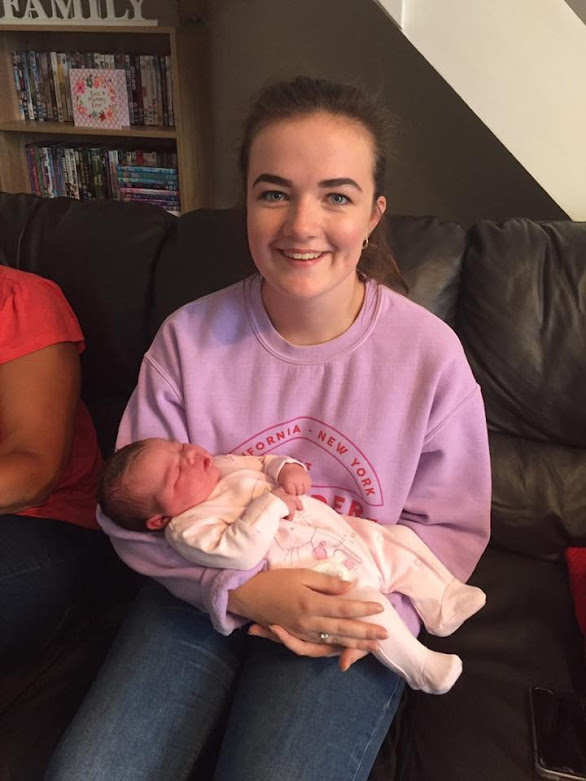 Teenage girl holding baby niece