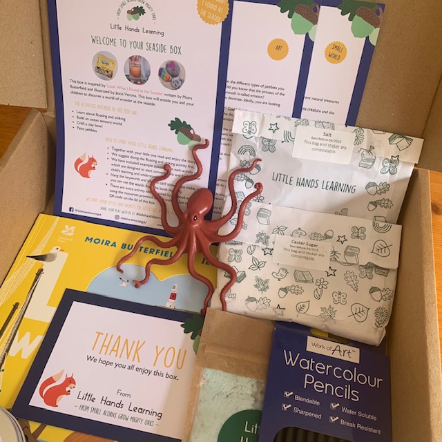 A seaside themed activity box, containing toy octopus and watercolour pencils