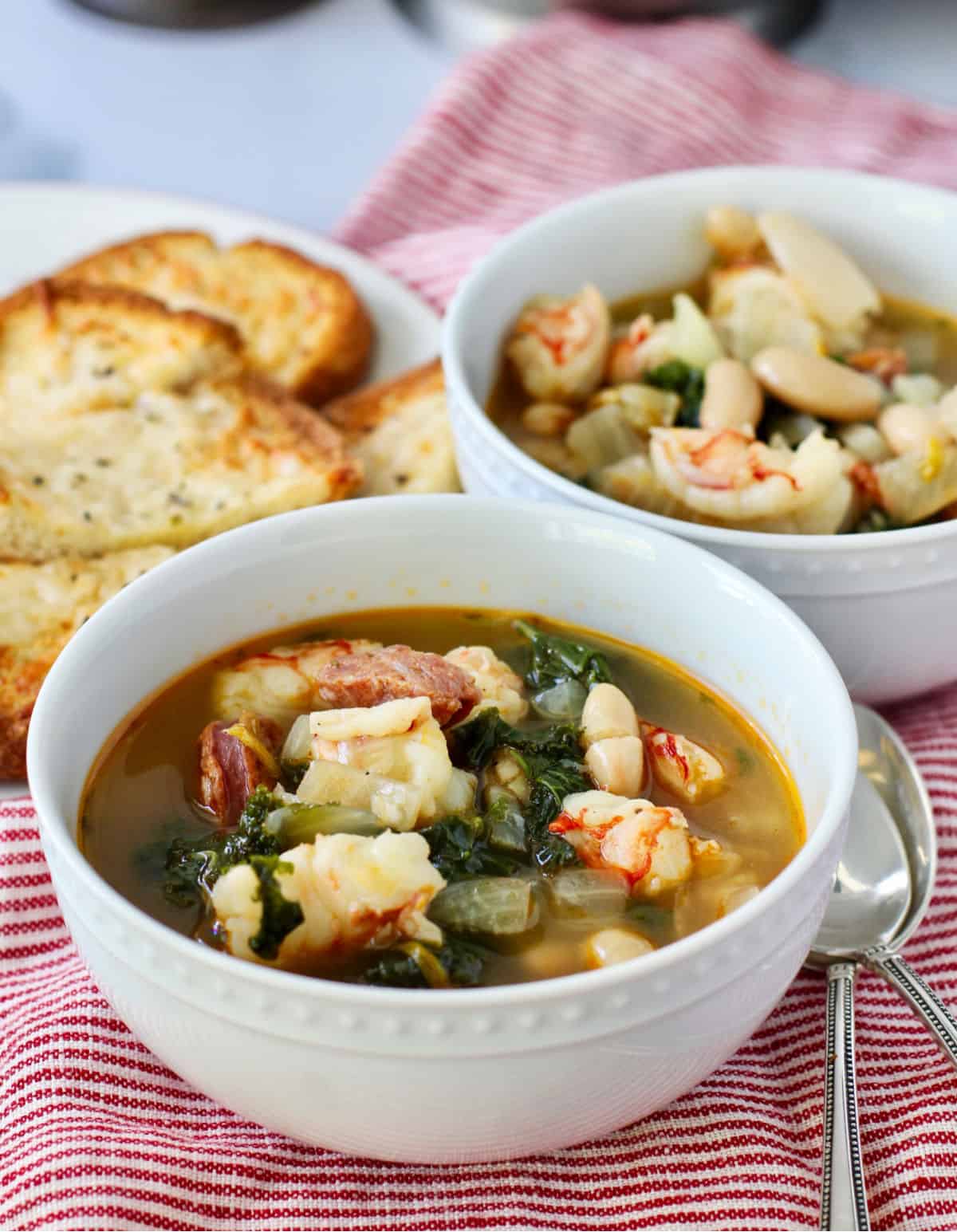 Shrimp, White Bean, and Kale Stew with Cheesy Garlic Bread on a plate.