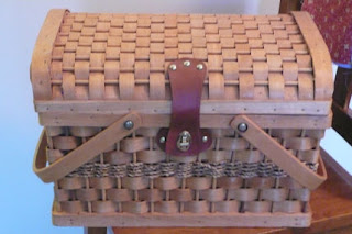 photo of a wicker picnic basket, lid closed