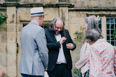 Me chuckling while removing glitter from my luscious locks, surrounded by concerned family members.