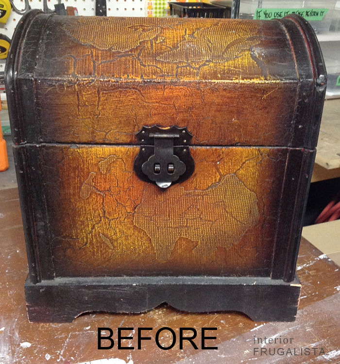 A small decorative trunk with faux snakeskin before getting a makeover.