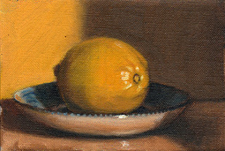 Oil painting of a lemon on a blue and white porcelain saucer.