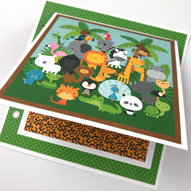 Zoo or Jungle themed scrapbook album page with lots of cute animals, prints, & palm trees