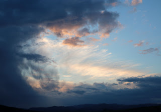 Swirling clouds like a wave caught mid-crash