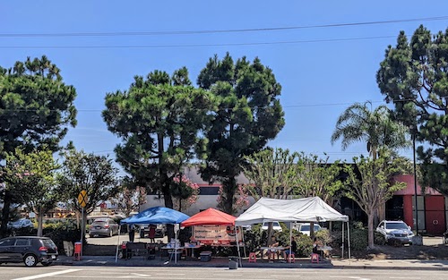 Tents, tables, and cooking setup on Susana Road