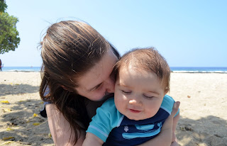 mama with her sweet toddler boy. snuggling on the beach