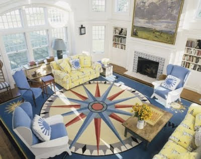 In this living room a large nautical compass rug sets the stage. Sofas 