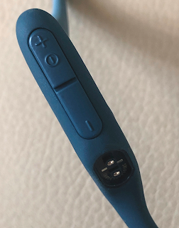 close-up of Shokz OpenRun Pro bone conduction headphones control buttons