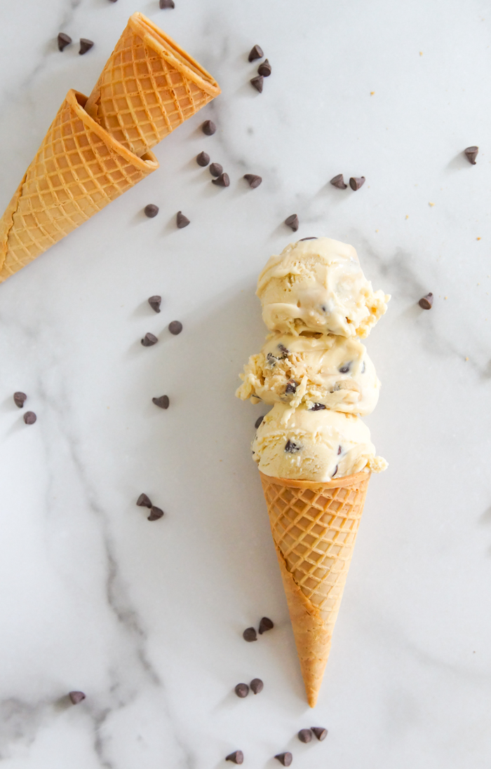 cookie dough ice cream, on cone on marble surface