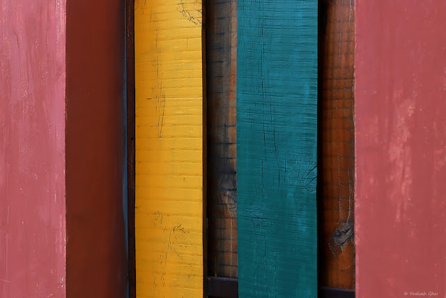 A Colorful Minimal Art Photograph of Multi colored stripes of painted Wood. 