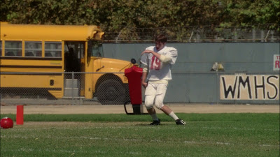 Ryder in a football uniform doing an endgame dance on the football field during practice