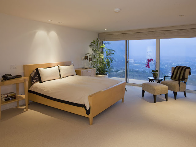 Picture of modern minimalist bedroom with wooden bed and the city views