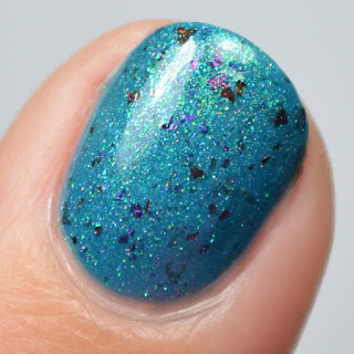 blue shimmer nail polish with flakies