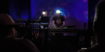 Humanoid No More, two DJs on stage with a space themed backdrop and DJ gear in front of them