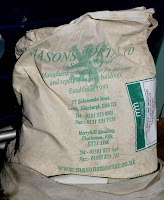 Bag of Mason's dry lime mortar mix.