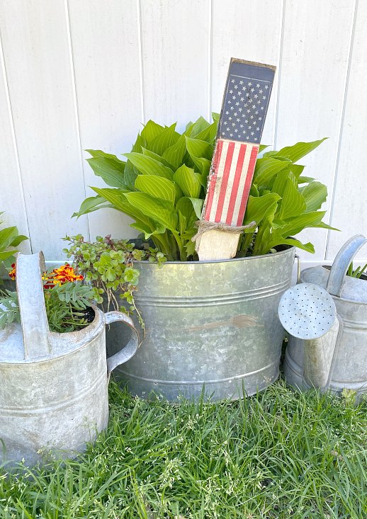 American flag plant stake in galvanized pots