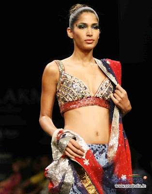Model in Red and Blue Designer Saree paired with Sleeveless Designer Saree 