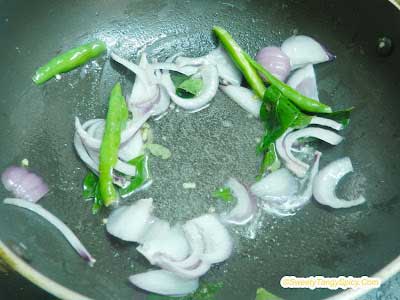 Sauteing Onions, Green Chilies, and Curry Leaves in Hot Oil