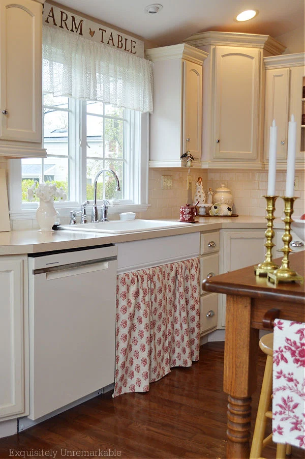 Cottage Style Kitchen with sink skirt and lace valance and wooden island