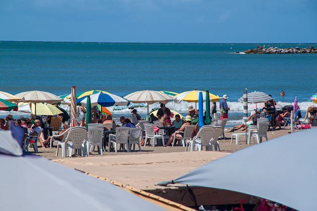 Gente , sombrillas, playa y mar