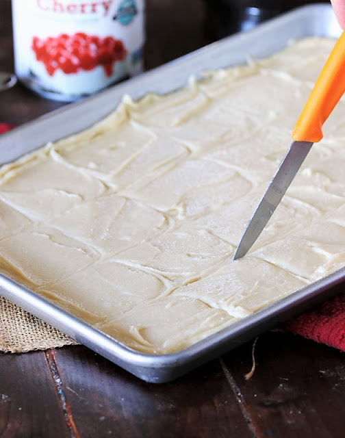 Scoring Holiday Cherry Squares Batter With a Knife Image