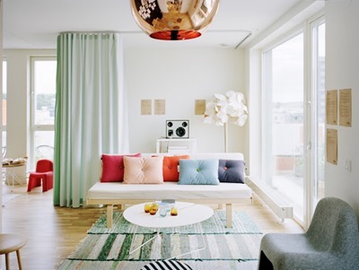 living room mint green drapery drapes curtain copper tom dixon pendant stripe striped rugs carpeting flooring floor colorful sofa cococozy