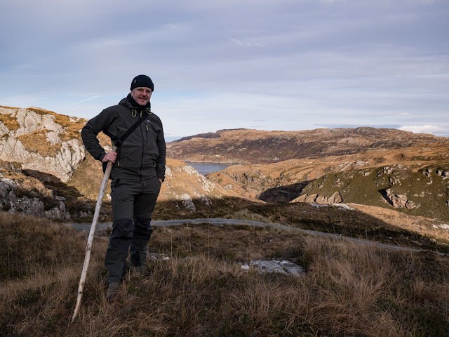 Bob Marshall standing roughly half way along Calum's Road where the road drops steeply down towards a small inlet at the head of Loch Arnish
