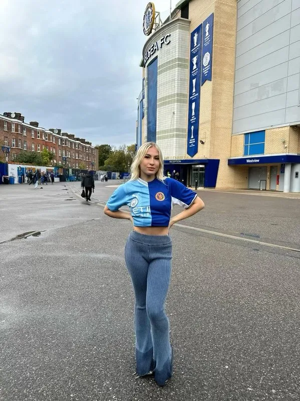 OnlyFans model Astrid Wett wears half-and-half Chelsea & Manchester City shirt