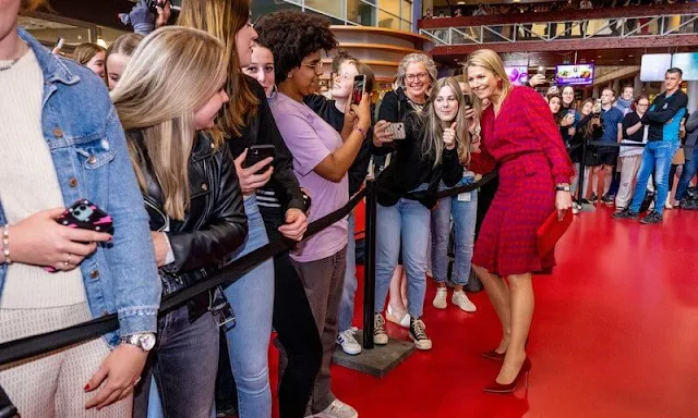 Queen Maxima wore a her Tory Burch Judi red tulip printed tie-waist multiple colors dress. Gianvito Rossi red pumps