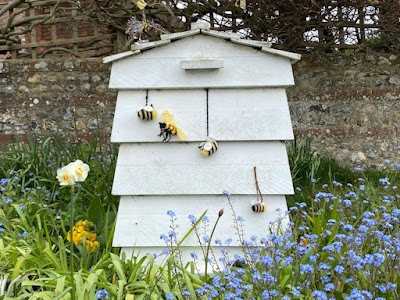 Beehive with knitted bees