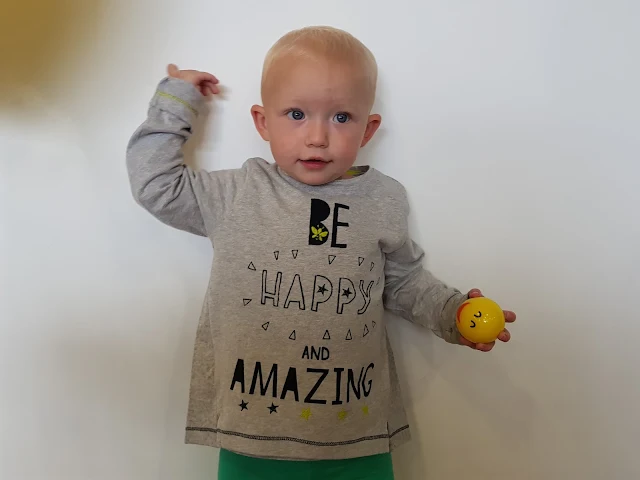 Little in a long sleeve tee from the Fearne collection with the slogan "Be happy and Amazing"