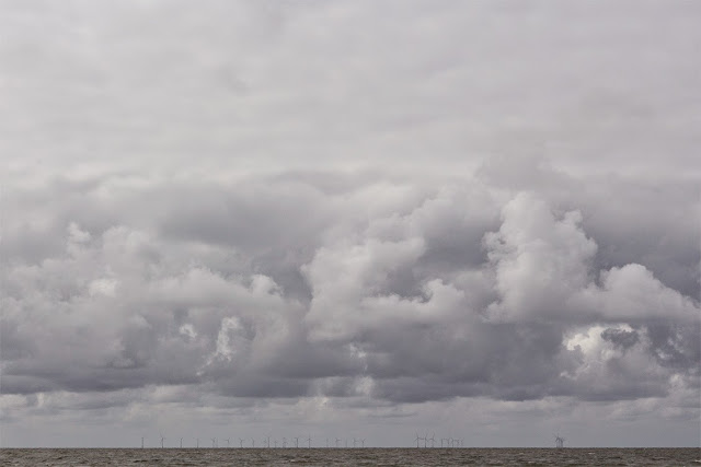 amazing sky with wind mills on horizon