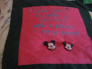 Salmony pink figured background with puff-painted message and Mickey & Minnie pieces