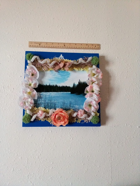 one of my pictures on a painted board with flower embellishments