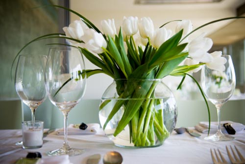 A footed bowl of shells is hard to beat White tulips in a goldfish bowl