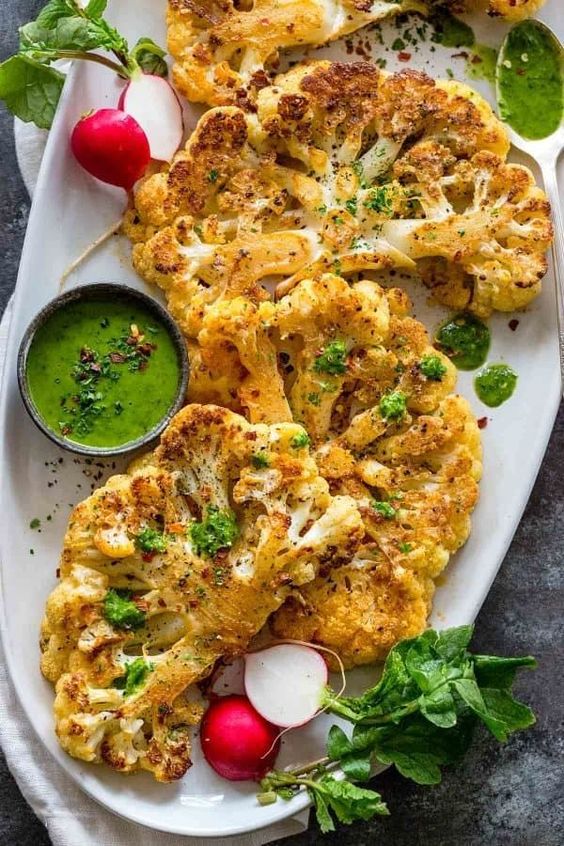 Cauliflower steaks are easy to make entre that is oven roasted with simple seasonings like salt, pepper, garlic powder, and paprika. Serve the vegetable steak with a flavorful sauce or toppings for a customizable dish. Cauliflower steaks are easy to make entre that is oven roasted with simple seasonings like salt, pepper, garlic powder, and paprika. Serve the vegetable steak with a flavorful sauce or toppings for a customizable dish.