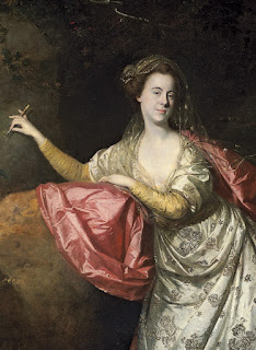 A portrait of a pretty young woman who is attired in old fashioned dress and appears to be leaning against a large boulder while holding what appears to be a metal pen like tool with which she is engraving something into the stone running up from the boulder.  The portrait is a detail of Ann Brown (Cargill) painted by Johann Zoffany.
