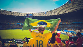 A Brazilian fan cheers for his team during a soccer match