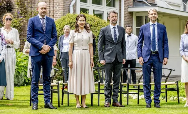 Crown Princess Mary wore an Aahna puff-sleeve belted wool dress by Beulah. Chanel leather and fabric cap toe slingback flats sandals