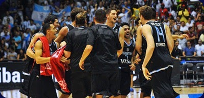 Argentina's players celebrate after winning the 2014 FIBA World basketball championships group B match Senegal vs Argentina at the Palacio Municipal de Deportes in Sevilla on September 3, 2014.  AFP PHOTO / CRISTINA QUICLER