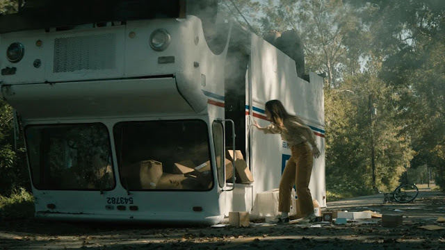 kaitlyn dever and an upside down mail truck