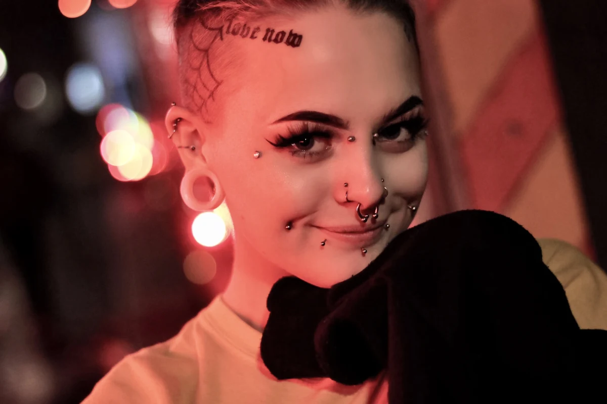 a portrait of a beautiful woman with piercing and tattoo