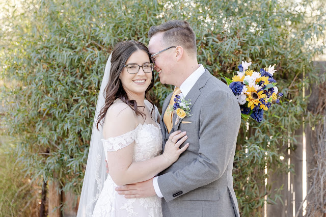 bride and groom portrait with greenery backdrop