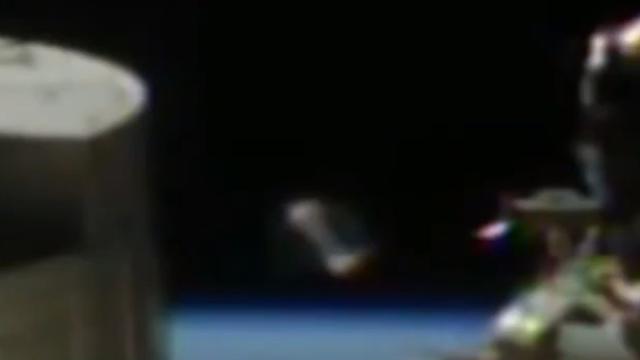 Amazing type of cylinder UFO with caps at each end next to the ISS.