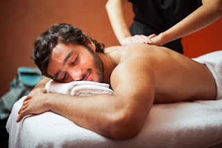 A Man Getting Massage in a Exotic Spa Center.