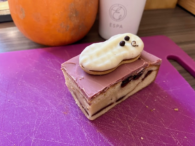 a piece of cake with a peanut on top